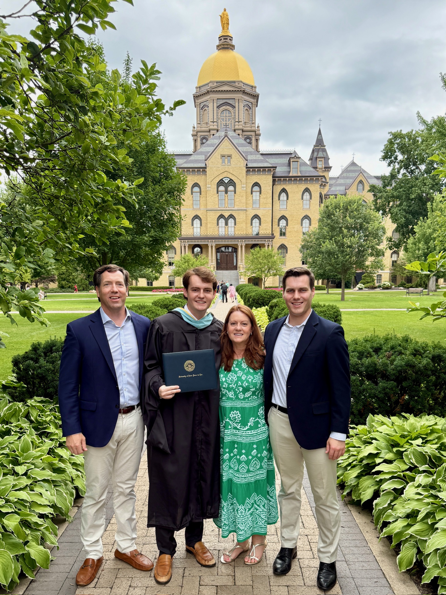 Aidan Anderson and his family posing for a photo outside the Main Building