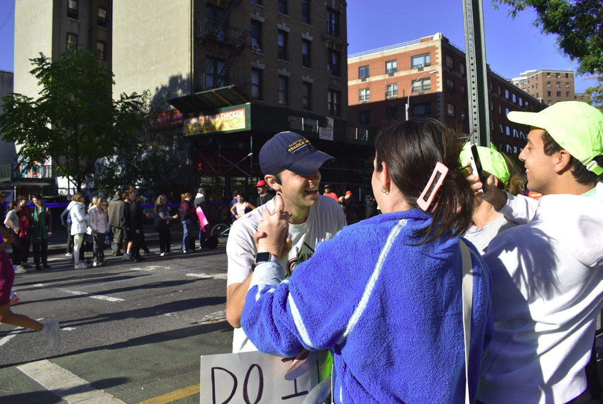 Jack Hutter stopping to say hi to friends and family at the NYC Marathon 2025