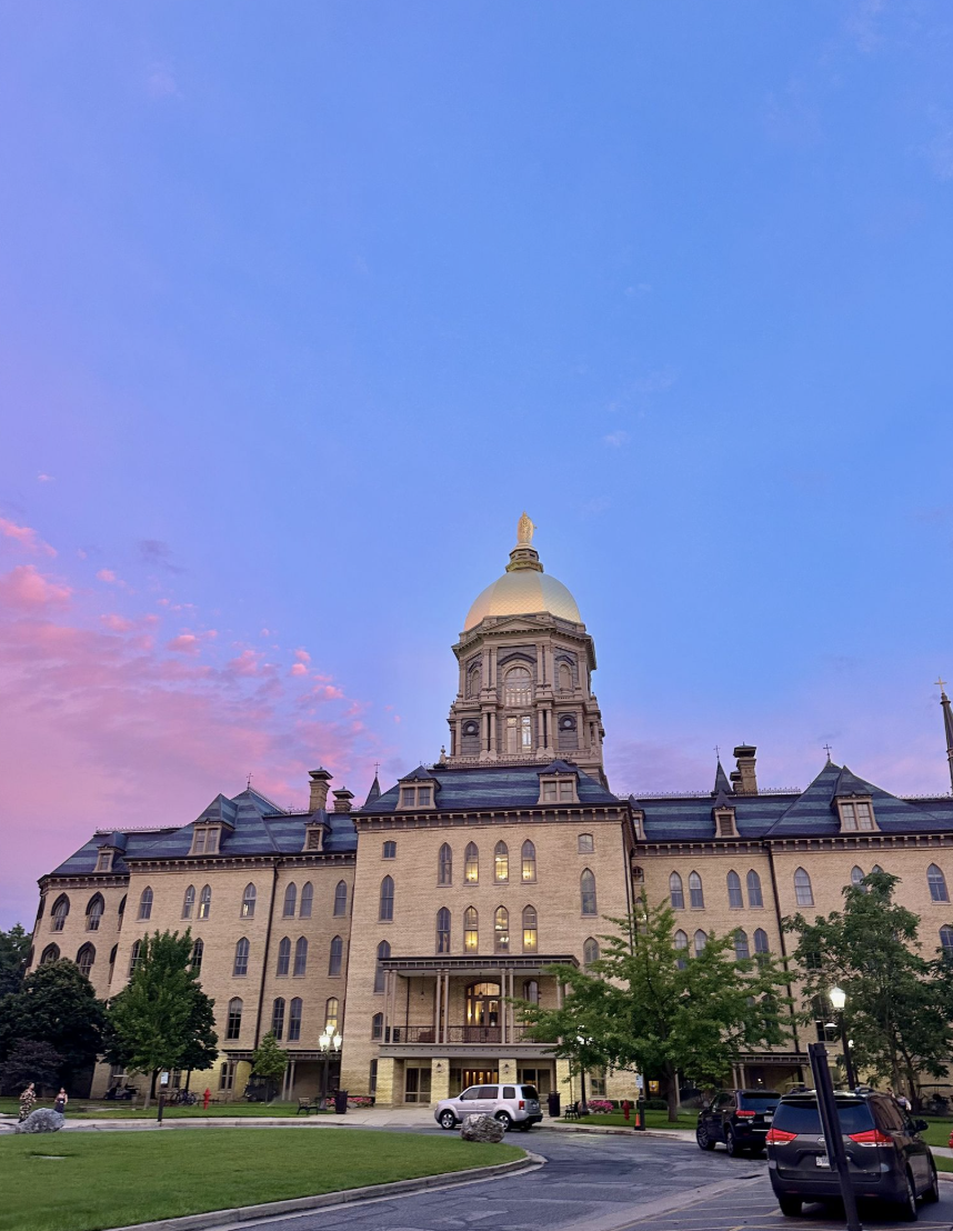 Image of Main Building at Notre Dame with a purple-pink sky 