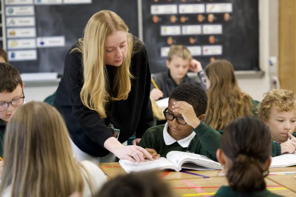 Teacher assisting student
