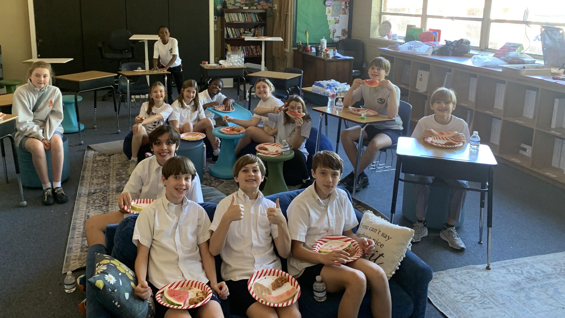 Ms. Hall's sixth grade home room posing for a photo from their Christmas party.